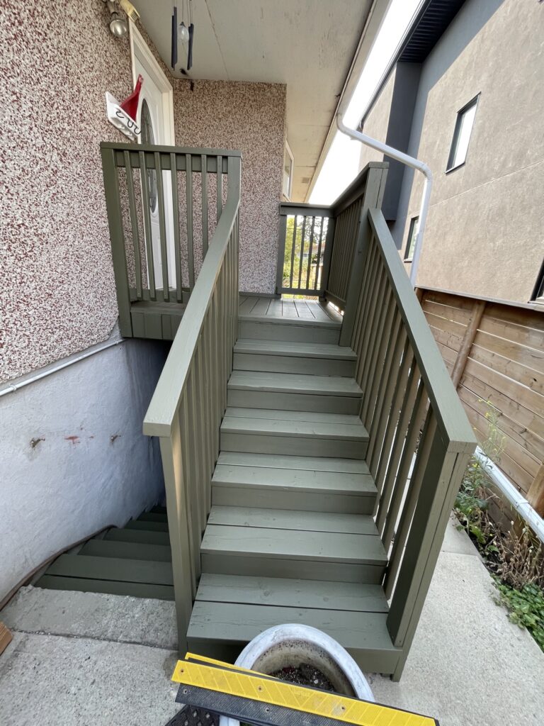 Freshly painted wooden deck stairs by Renovo Painting Inc, Calgary