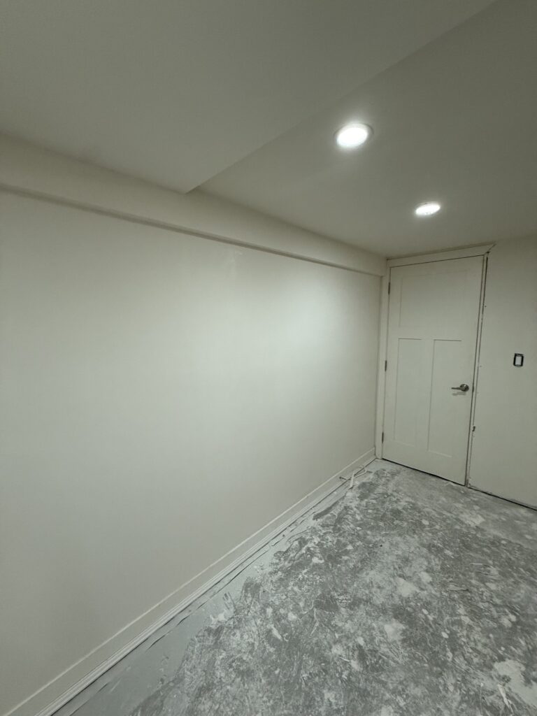 Finished basement room with pot lights by Renovo Painting Inc, Calgary