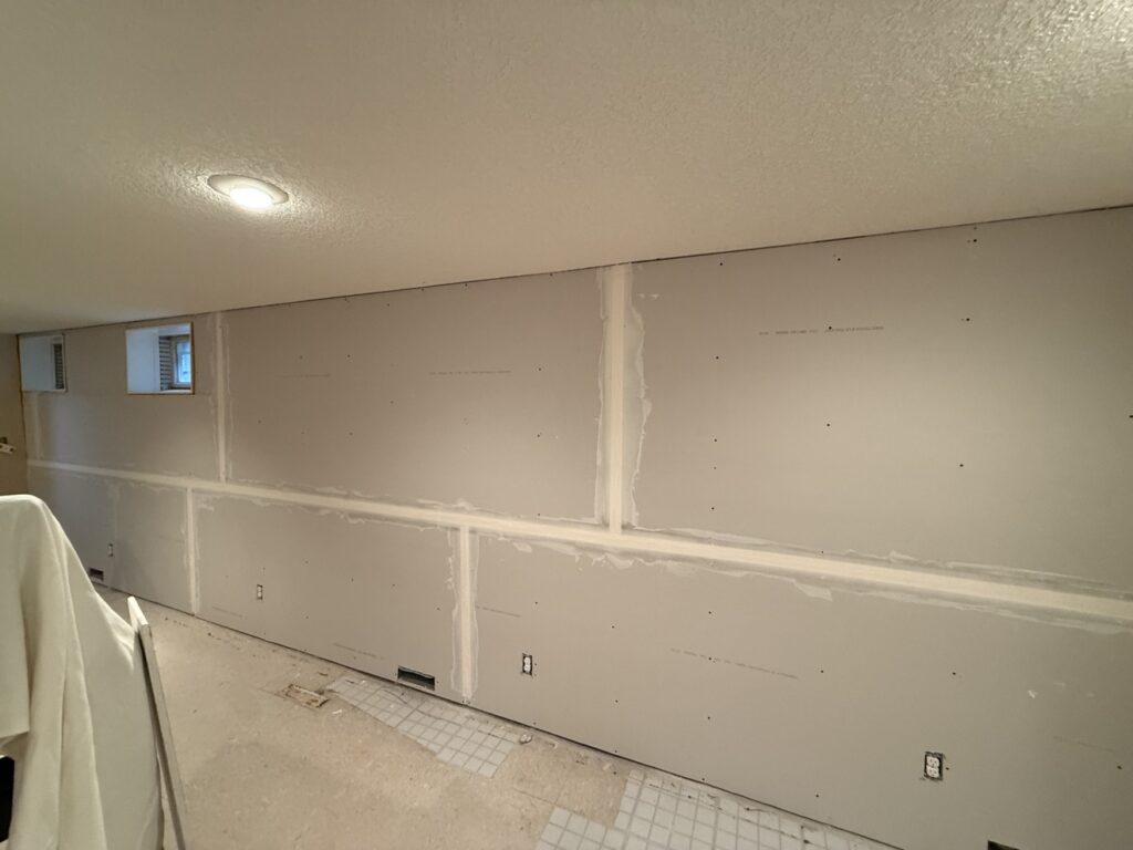 Basement drywall taped and mudded by Renovo Painting Inc, Calgary