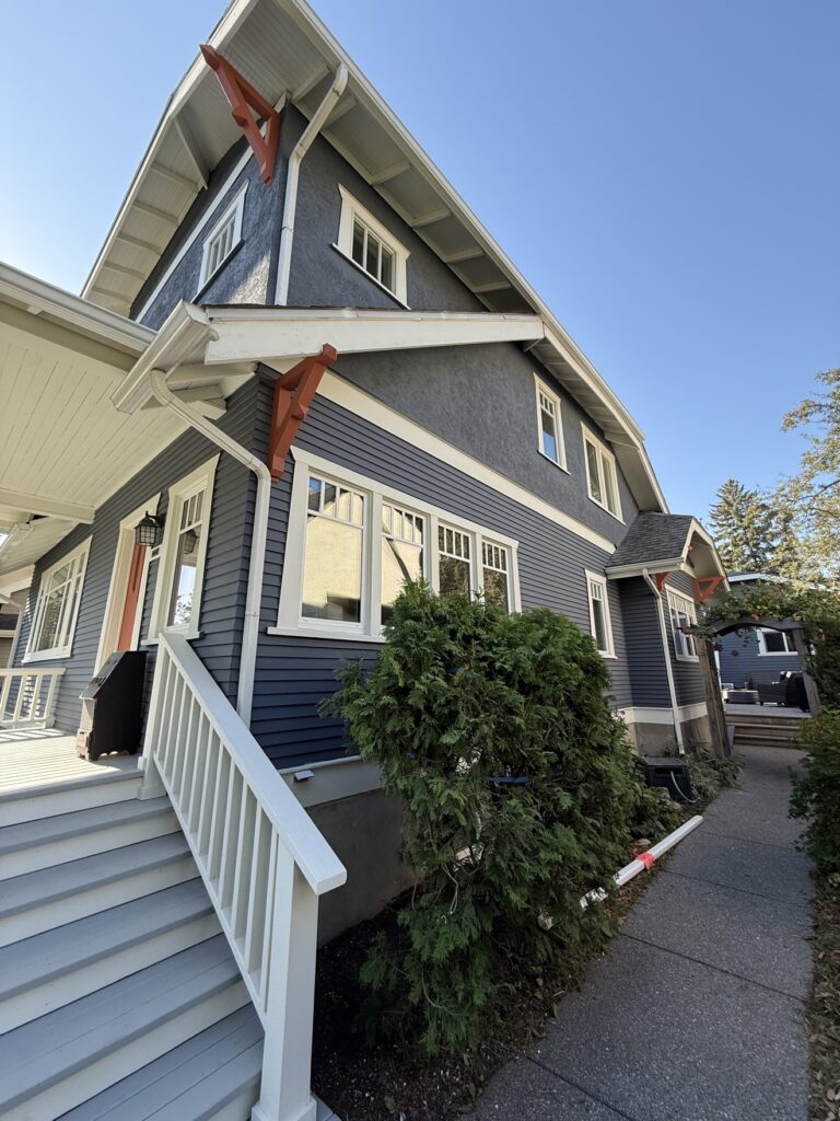 Freshly painted house porch and siding by Renovo Painting Inc, Calgary
