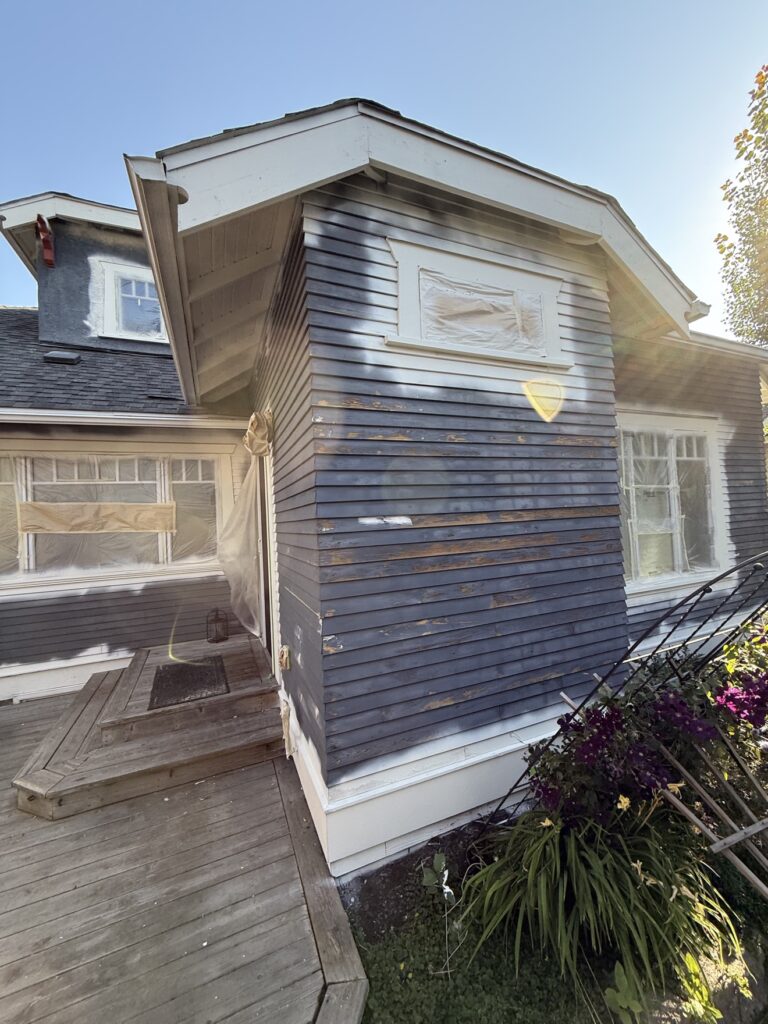 Real scraped siding corner during preparation by Renovo Painting Inc, Calgary