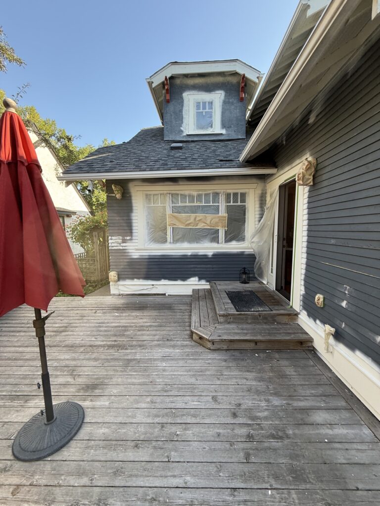 Deck railing mid-paint by Renovo Painting Inc, Calgary