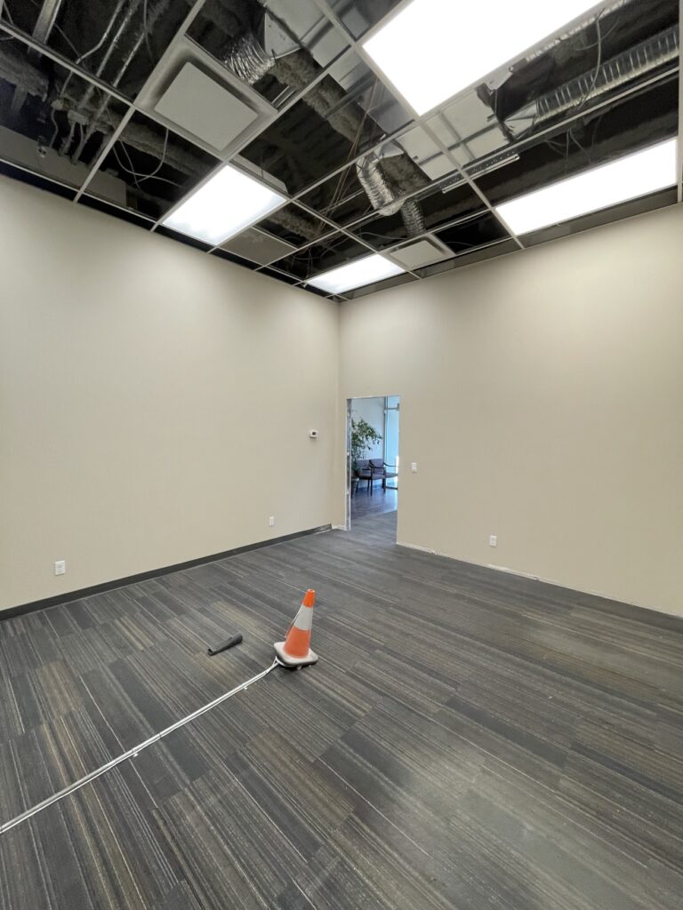 Office buildout room with painted walls by Renovo Painting Inc, Calgary
