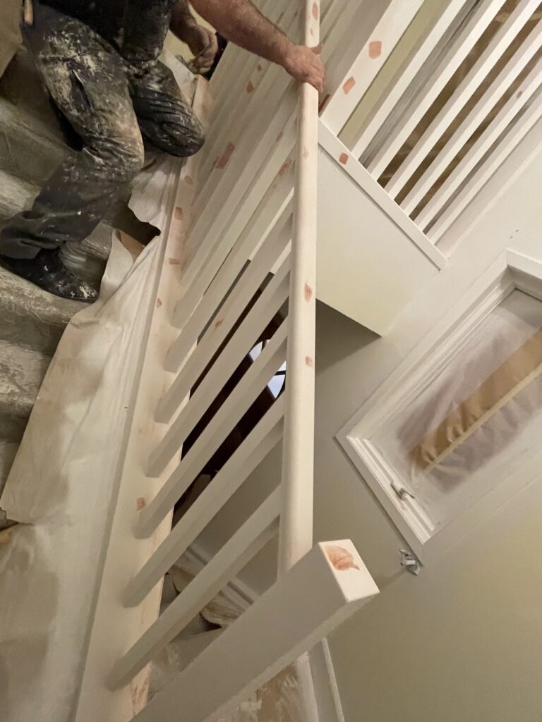 Wooden railing during preparation for painting by Renovo Painting Inc, Calgary